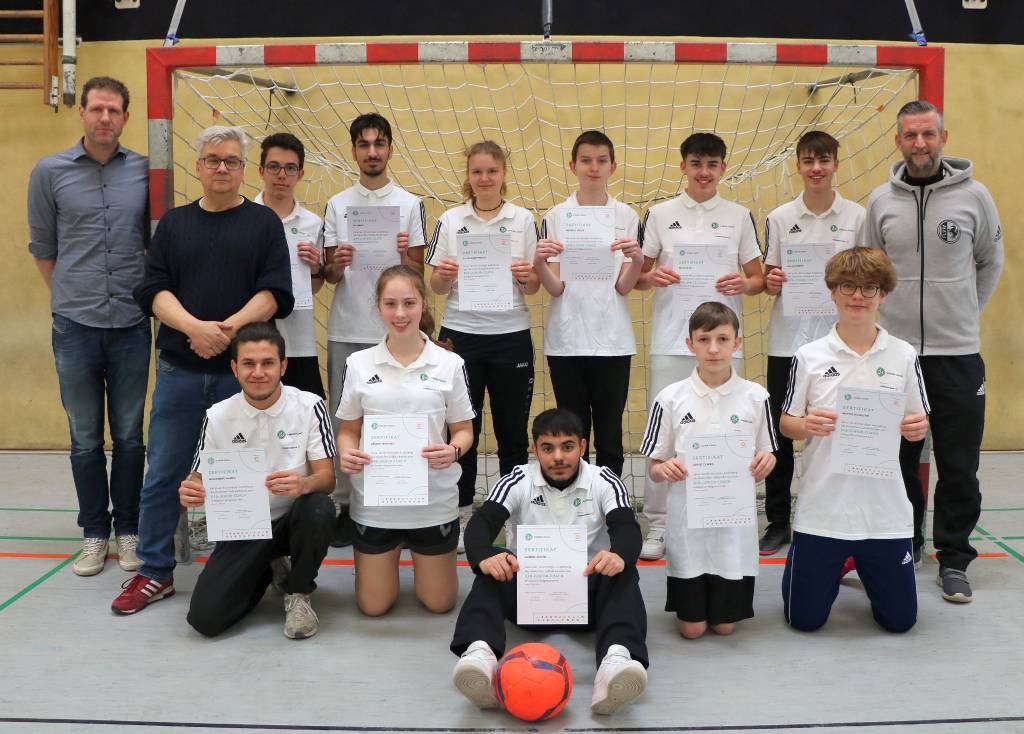 Die neuen DFB-Junior-Coaches mit Daniel Gohrke (l.), Arbeitskreis Schulsport der Stadt Recklinghausen, Thomas Synowczik vom FLVW (r.) und dem stellvertretenden Leiter der Wolfgang-Borchert-Gesamtschule, Martin Dambeck.