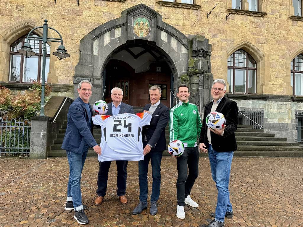 Sie freuen sich auf das Public Viewing vor dem schönsten Rathaus von NRW (v.l.): Lars Tottmann (Arena RE GmbH), Erster Beigeordneter Ekkehard Grunwald, Bürgermeister Christoph Tesche, Marius Ebel (Arena RE GmbH) und Hendrik Eßers (Leiter Fachbereich Wirtschaftsförderung, Standortmanagement, Stadtmarketing). Foto: Stadt RE