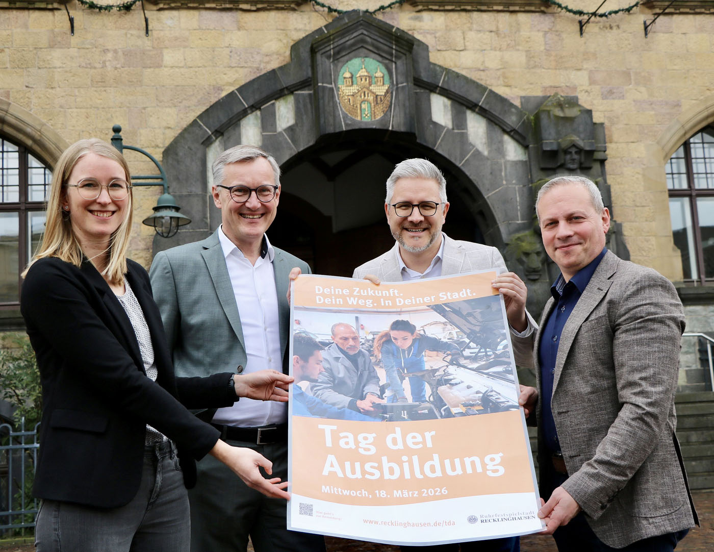 Sabine H&uuml;ffmann (Wirtschaftsf&ouml;rderung), B&uuml;rgermeister Axel Tschersich, Hendrik E&szlig;ers (Fachbereichsleiter Wirtschaftsf&ouml;rderung) und Ihnatiy Jablonowski (Fachbereichsleiter Personal, v.li.) laden ein zum Tag der Ausbildung. Foto: Stadt RE